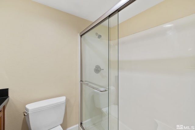 bathroom with vanity, toilet, and an enclosed shower