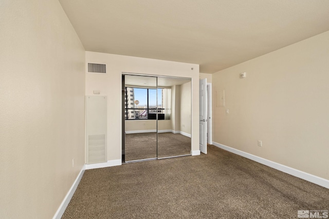 unfurnished bedroom with a closet and carpet