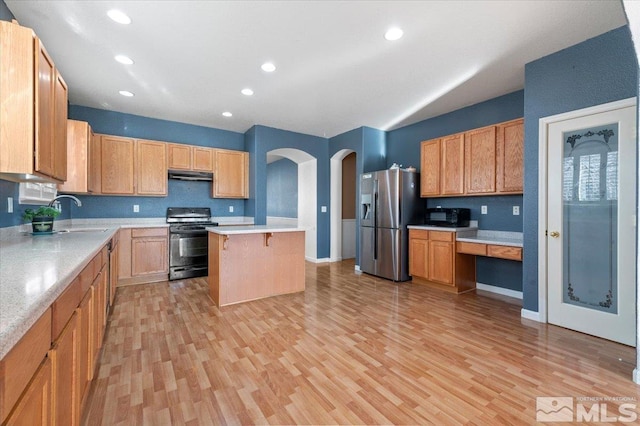 kitchen featuring sink, a center island, black appliances, and light hardwood / wood-style floors