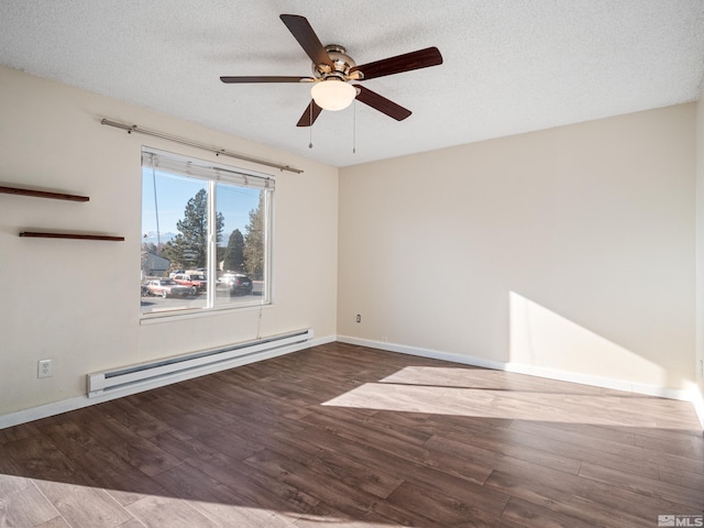 spare room with a textured ceiling, dark hardwood / wood-style floors, and a baseboard heating unit