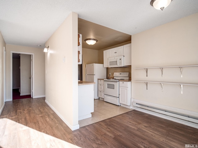 kitchen with white cabinets, a baseboard radiator, white appliances, and light wood-type flooring