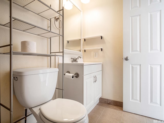 bathroom with tile patterned floors, vanity, and toilet