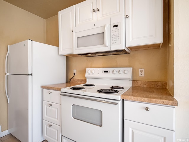 kitchen with white cabinetry and white appliances