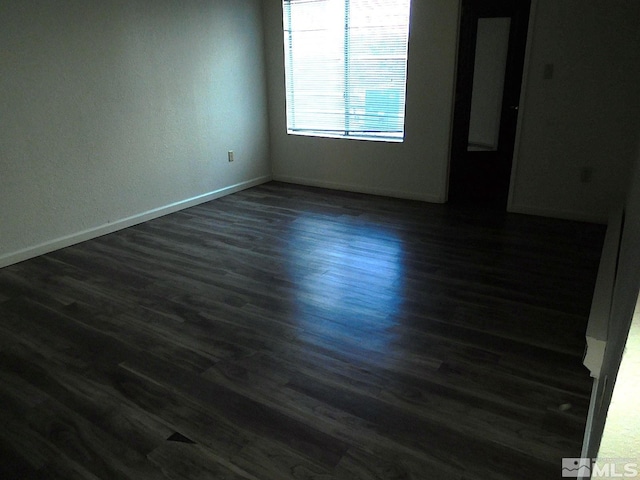 empty room with dark hardwood / wood-style floors