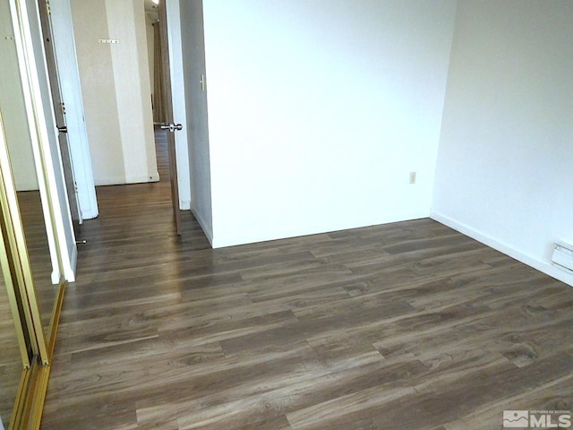 spare room featuring dark hardwood / wood-style floors