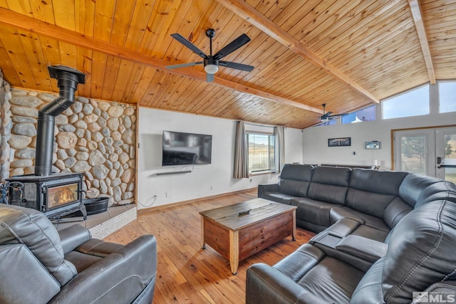 living room featuring french doors, lofted ceiling with beams, wooden ceiling, light hardwood / wood-style floors, and a wood stove