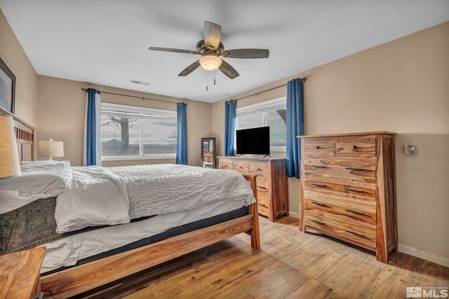 bedroom with ceiling fan and light hardwood / wood-style floors