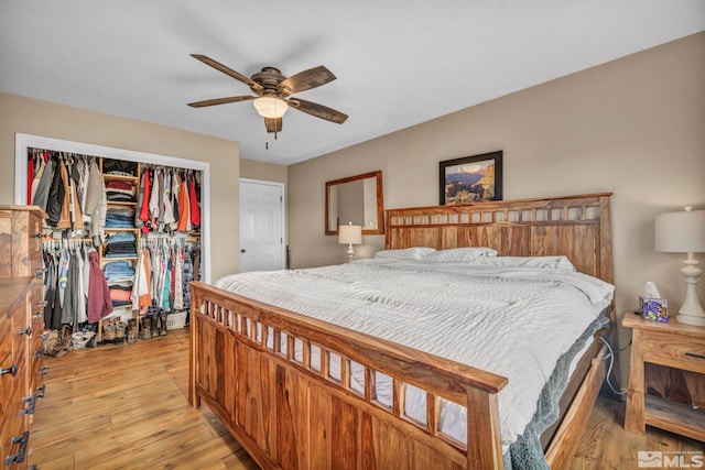 bedroom featuring ceiling fan, light hardwood / wood-style floors, and a closet