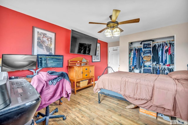 bedroom featuring ceiling fan, a closet, and hardwood / wood-style floors