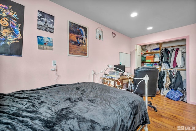 bedroom featuring hardwood / wood-style flooring and a closet