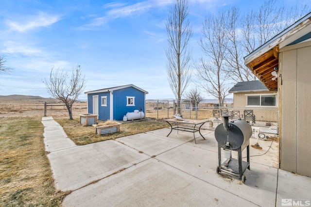 view of patio with area for grilling and a storage shed