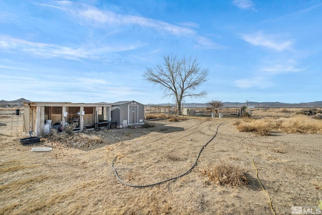 view of yard with a rural view and a shed