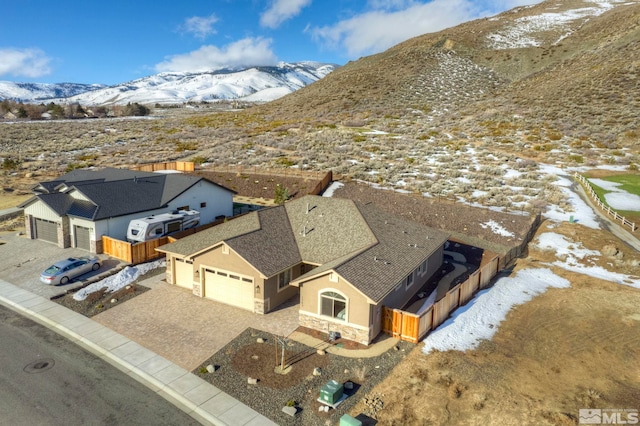 snowy aerial view featuring a mountain view