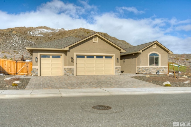 view of front of property featuring a mountain view and a garage