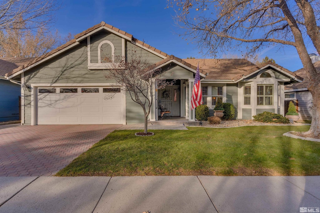 view of front of property featuring a front lawn and a garage