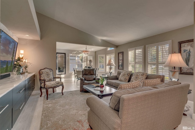 living room with light hardwood / wood-style flooring and vaulted ceiling