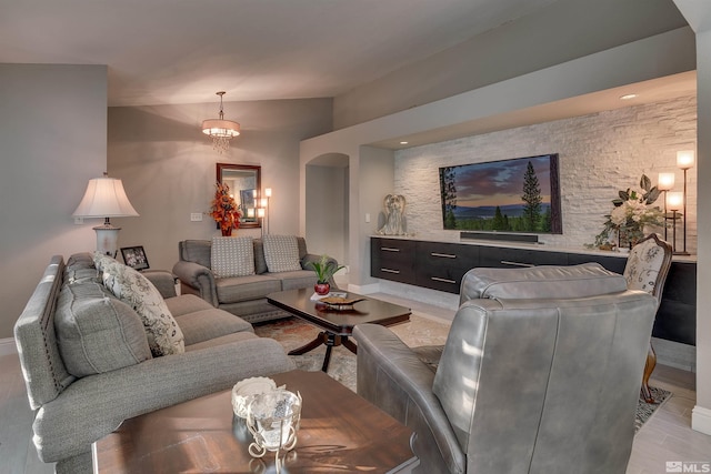 living room featuring light hardwood / wood-style flooring and an inviting chandelier