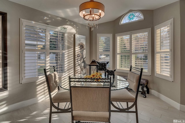 dining space featuring lofted ceiling and a chandelier