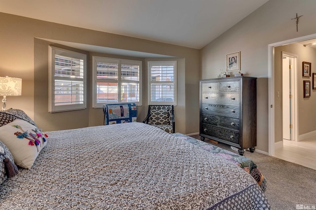 bedroom with carpet floors, multiple windows, and lofted ceiling