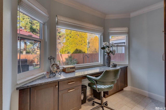 office area with light hardwood / wood-style floors, built in desk, and ornamental molding