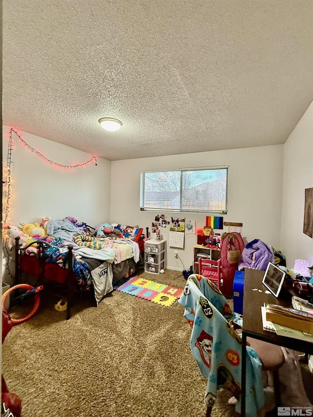 bedroom with carpet floors and a textured ceiling