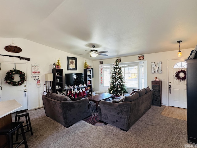 carpeted living room featuring ceiling fan and lofted ceiling