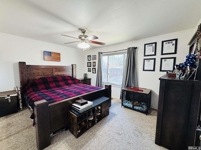 carpeted bedroom with a textured ceiling and ceiling fan