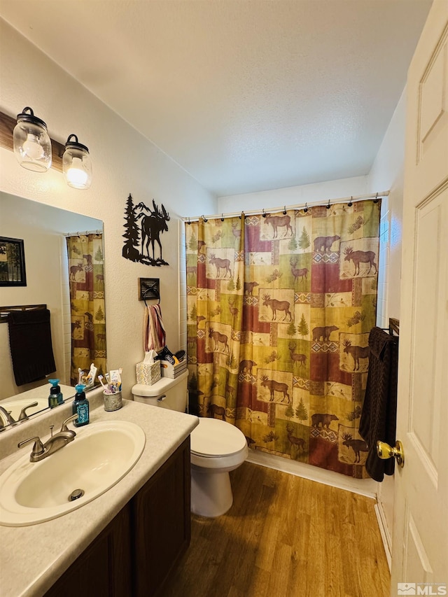 full bathroom with toilet, vanity, shower / bath combo, and hardwood / wood-style flooring