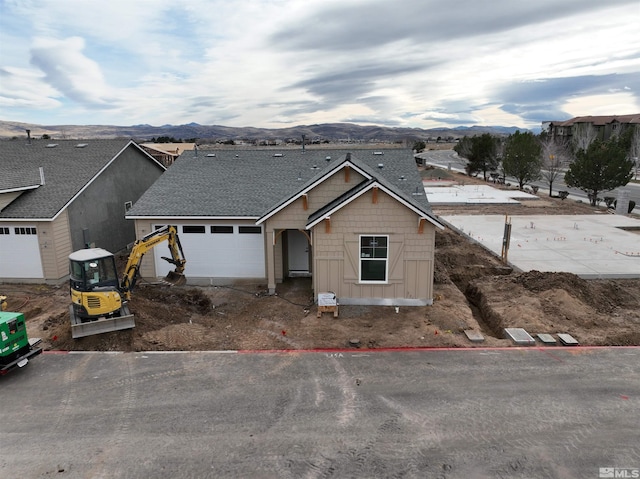 view of front of home featuring a mountain view and a garage