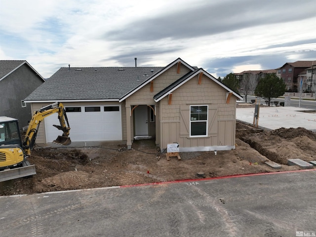 view of front of house featuring board and batten siding, roof with shingles, and a garage