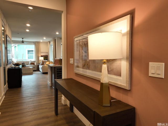 hall with dark wood-style flooring and recessed lighting