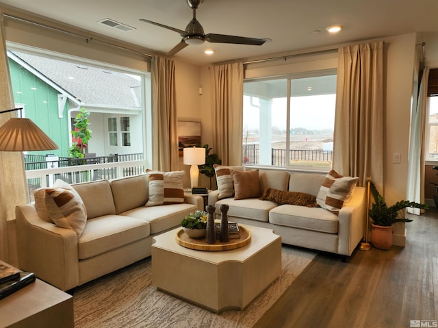 living area with a ceiling fan, visible vents, wood finished floors, and recessed lighting