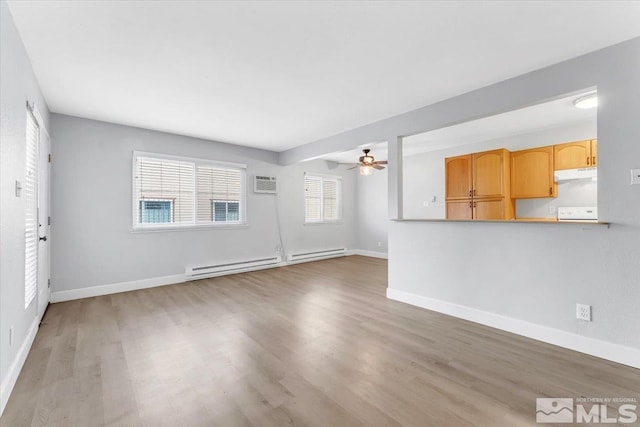 unfurnished living room featuring ceiling fan, baseboard heating, a wall mounted AC, and light hardwood / wood-style flooring