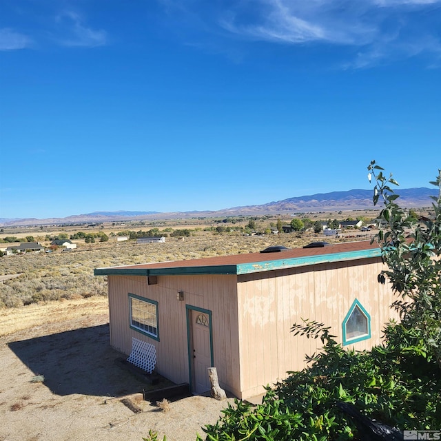 view of outbuilding featuring a mountain view