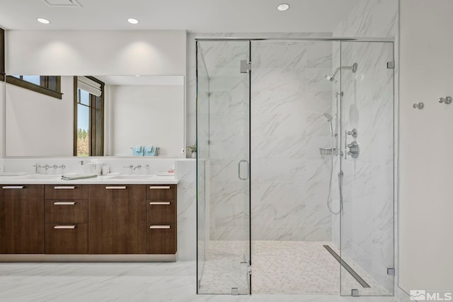 bathroom featuring vanity and a shower with shower door