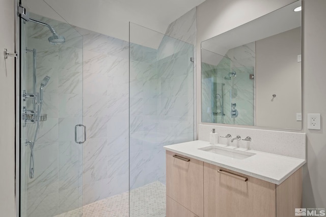 bathroom with tile walls, vanity, and an enclosed shower