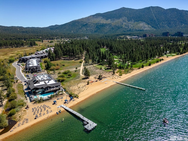 birds eye view of property featuring a view of the beach and a water and mountain view