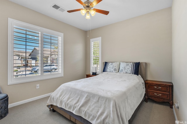 bedroom featuring carpet, multiple windows, and ceiling fan