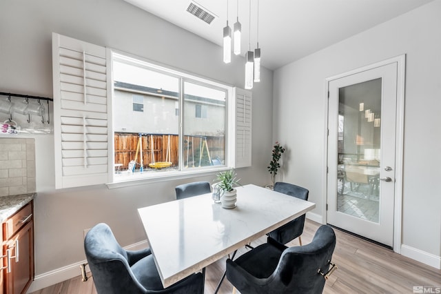 dining space featuring light wood-type flooring