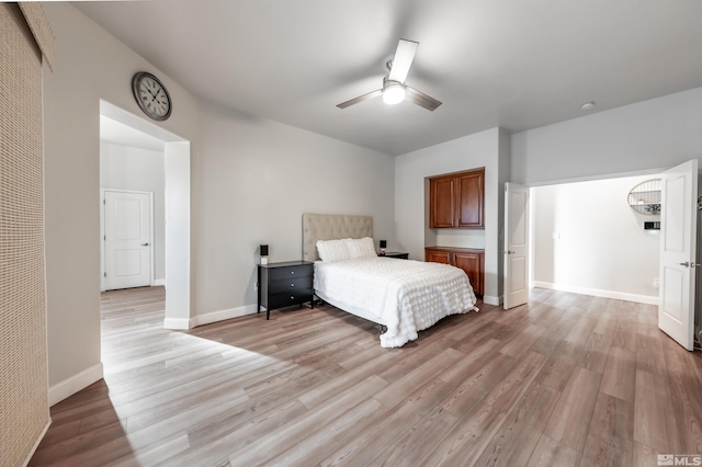 bedroom with ceiling fan and light wood-type flooring