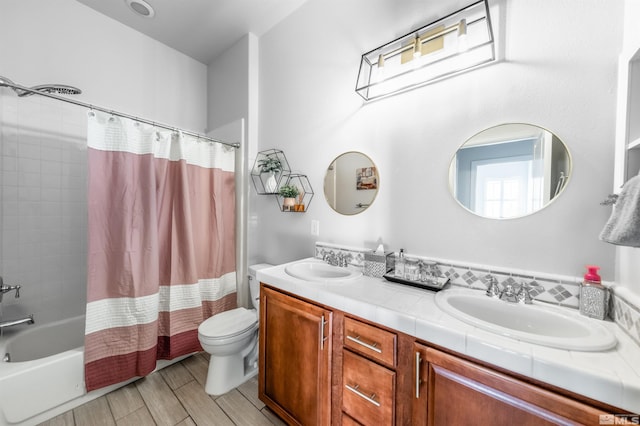 full bathroom featuring vanity, shower / bath combo, and toilet