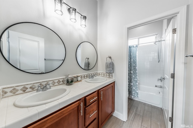 bathroom featuring shower / bath combination with curtain, wood-type flooring, and vanity