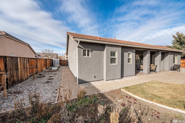 rear view of property featuring a patio area