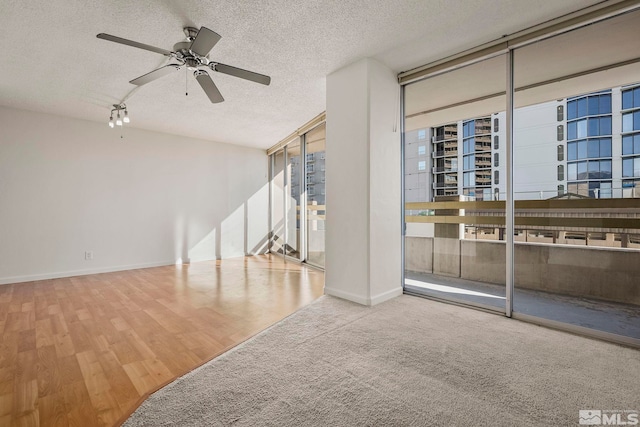 spare room featuring a textured ceiling, hardwood / wood-style flooring, and ceiling fan