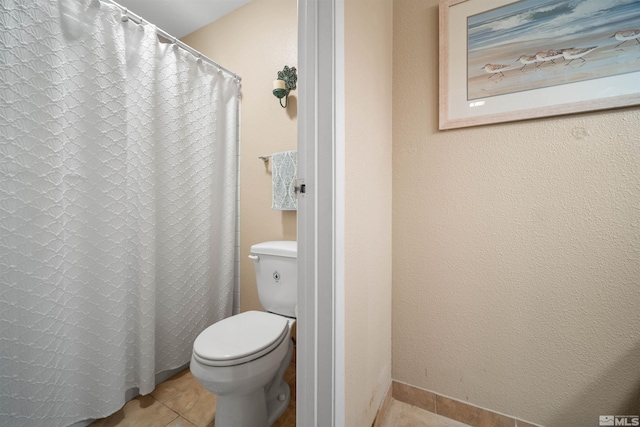 bathroom featuring tile patterned floors and toilet