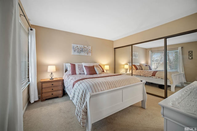 bedroom featuring light carpet and a closet