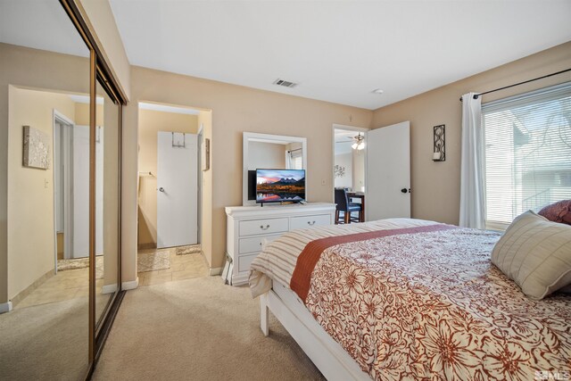 bedroom featuring light carpet and a closet