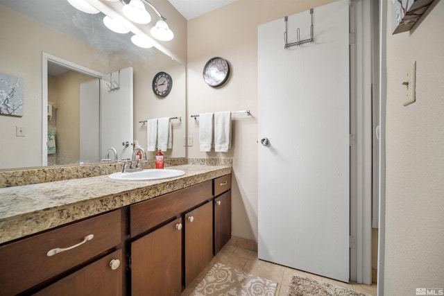 bathroom featuring tile patterned flooring and vanity