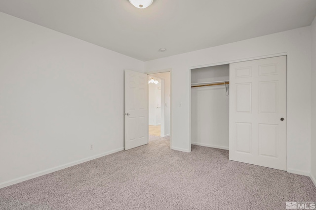 unfurnished bedroom featuring carpet flooring and a closet