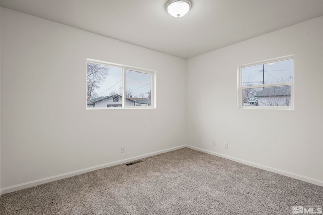 carpeted empty room featuring a healthy amount of sunlight